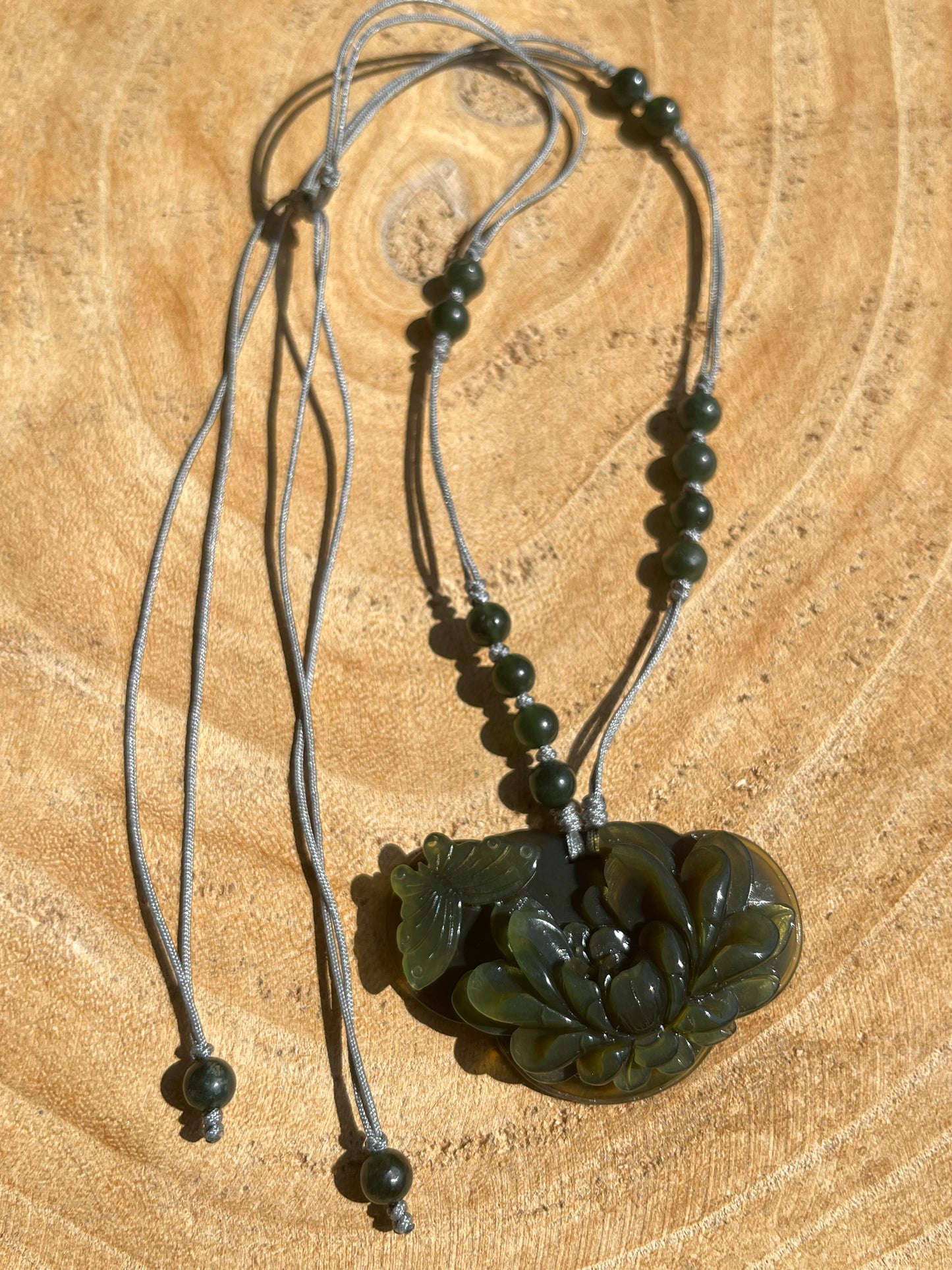 Hand Carved Tea Green Xiu Jade Peony and Butterfly Ruyi Pendant